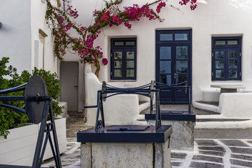 Mykonos, Greece Three Wellls area at Chora.Tria Pigadia area outside whitewashed bar with blue door and windows at Mykonos Town. © bestravelvideo
