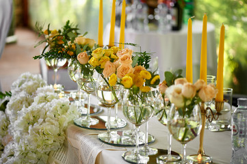 Yellow flowers details of the wedding table decorated with flowers. Floristic