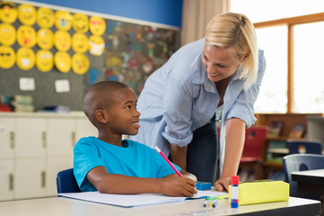 Teacher helping boy with homework