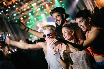 Group of friends having great time on music festival