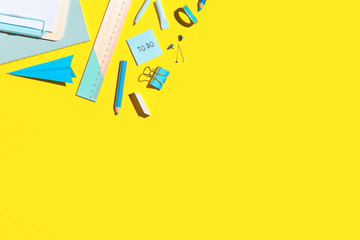 Back to school Flat lay. School supplies on yellow table. Copy space.
