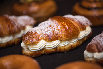 Cream croissant on dark background