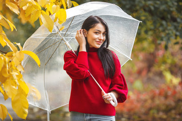 Cheerful young woman with umbrella