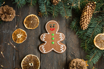 Gingerbread men laying on wood background. Christmas or New Year composition.