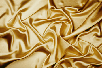 Gold luxury satin fabric texture for background