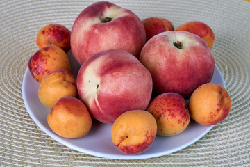 Fresh delicious apricot and peach fruits isolated on white background