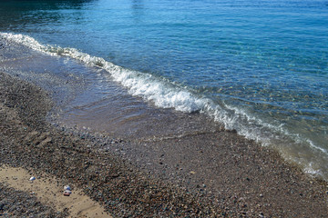 The sea view. Calm sea and large stones. Transparent water of the Adriatic Sea. Montenegro