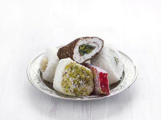 Traditional Turkish sweets lukum on a silver saucer