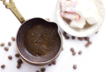 Turkish coffee in traditional jezve. Turkish sweets