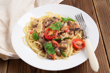 Spaghetti with mushrooms, tomatoes and cream sauce