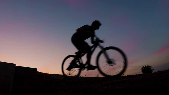 mountain bike jump sunset