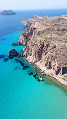 Aerial drone bird's eye view of volcanic and exotic rocky beach with turquoise and sapphire clear waters of Plathiena in island of Milos, Cyclades, Greece