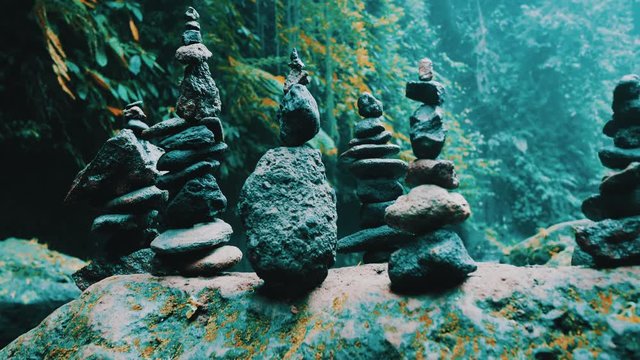 Stone zen balance towers in tropical jungle forest near waterfall