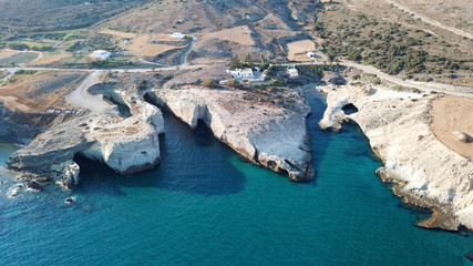 Aerial drone bird's eye view of iconic lunar volcanic white chalk caves and beach of Kapros next to famous caves of Papafragas, Milos island, Cyclades, Greece