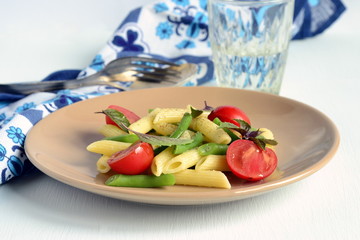 Penne pasta with green beans, cherry tomatoes and basil