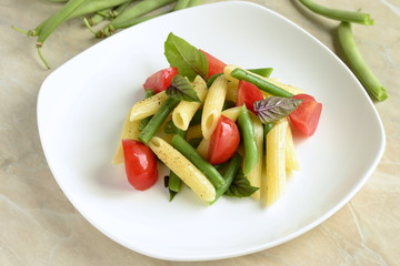 Penne pasta with green beans, cherry tomatoes and basil