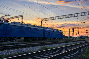 railroad infrastructure during beautiful sunset and colorful sky, trains and wagons, transportation and industrial concept