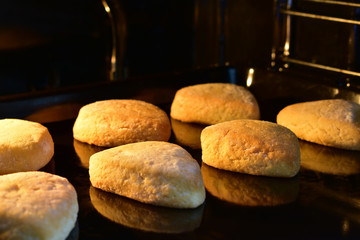 Baking pan with delicious cookies in the oven. Homemade cookies in the shape of a heart. A delicious dessert prepared with love. A light Breakfast prepared at home.