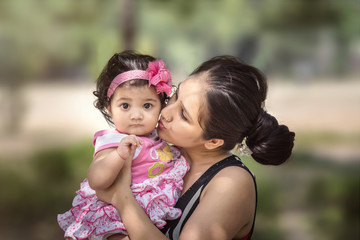 Happy loving family, Mother and daughter kissing and hugging.