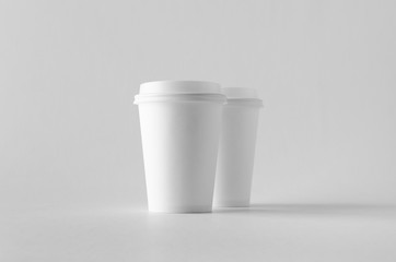 12 oz. white coffee paper cup mock-up with lid.
