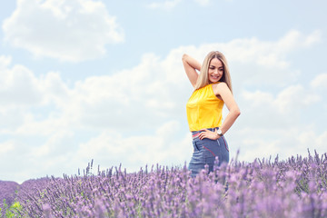 Naklejka na ściany i meble Portrait of cheerful young woman on lavender field.