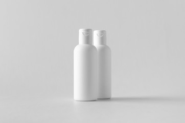 White plastic cosmetic lotion bottle mock-up with cap.