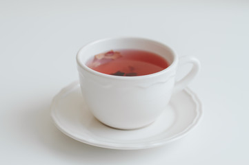 White cup with red herbal tea. Hibiscus tea. Healthy hot drink