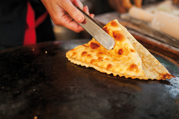 The process of cooking chebureks. The Caucasian and eastern food. Cooking in the streets.