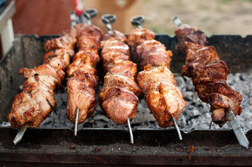 Preparation of shish kebab on barbeque. Roasting on charcoal in the open air