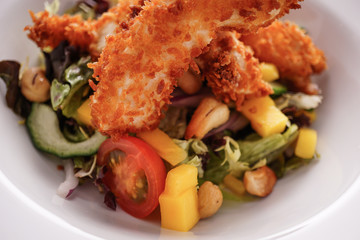Deep Fried Chicken Goujons Served with a Medley Of Mediterranean Vegetables. 