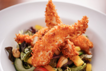 Deep Fried Chicken Goujons Served with a Medley Of Mediterranean Vegetables. 