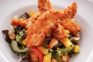 Deep Fried Chicken Goujons Served with a Medley Of Mediterranean Vegetables. 