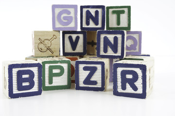 Colored wooden letter blocks on a white background with copy space