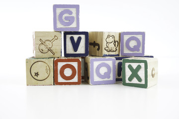 Colored wooden letter blocks on a white background with copy space