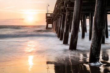 The waves splash along the Sandbridge Fishing Pier in Sandbridge Virginia, Virginia Beach during a...