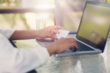 Fototapeta premium A young woman is holding an identification card to enter the computer system.