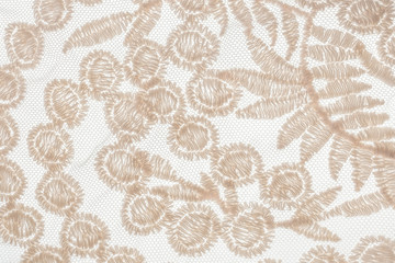 Romantic beige embroidered lacy canvas on white background. 
