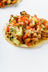 Close up of mexican taco with chili con carne, grilled sweet potatoes and grated cheese on white background. Text space