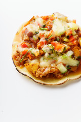 Close up of mexican taco with chili con carne, grilled sweet potatoes and grated cheese on white background. Text space