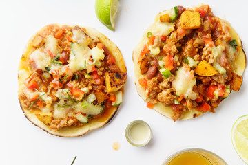 Mexican tacos with chili con carne, grilled sweet potatoes and grated cheese on white background. Text space