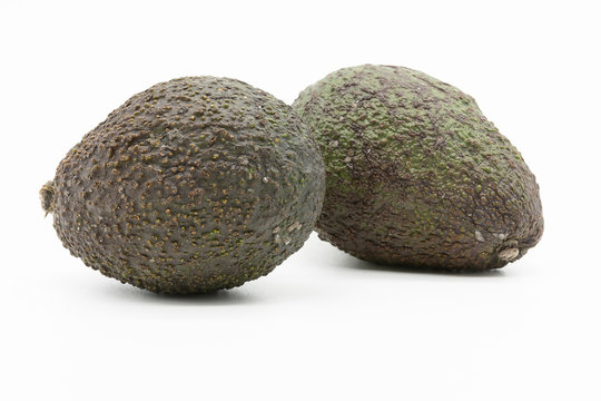 two avocados, isolated on white background