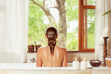 Woman relaxing in the bathtub