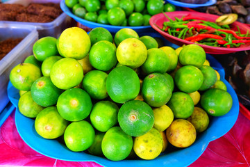 Lime or Green Lemon on the tray in the Vegetable shop in the food market.