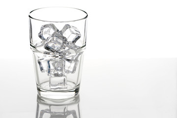 ice cubes in a transparent glass over white background