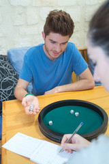 young couple playing five dice game