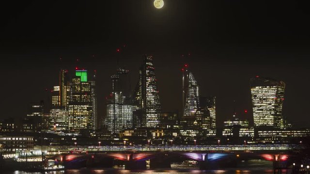 The moon rising over the City of London
