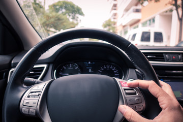 Man's hand touching an ecall button in the wheels's car