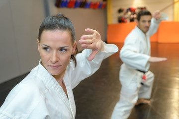 man and woman in karate class