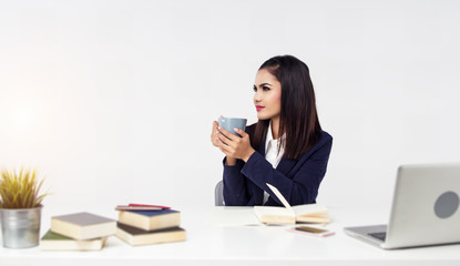 The business woman is working at office hour by laptop, mobile phone, and paperwork