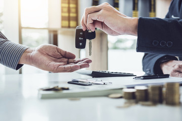 Salesman send key to customer after good deal agreement, successful car loan contract buying or selling new vehicle
